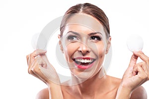 Happy woman holding makeup removing pads