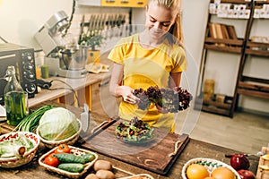 Happy woman holding salad, cooking healthy food