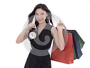 happy woman holding shopping bag and clock