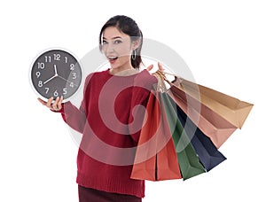 happy woman holding shopping bag and clock