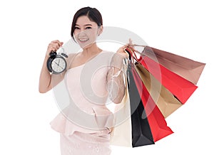 Happy woman holding shopping bag and clock isolate on white back