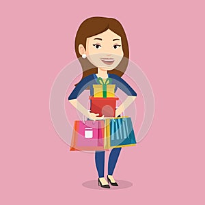 Happy woman holding shopping bags and gift boxes.