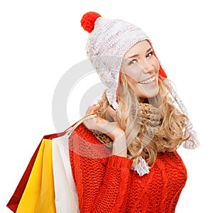 Happy woman holding shopping bags. Winter sales. Isolated.