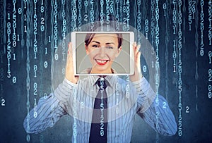 Happy woman holding tablet with her face displayed on a screen