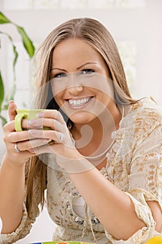 Happy woman holding tea cup