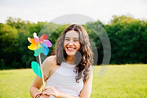 Happy woman holding a windmill toy