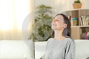 Happy woman at home breathing fresh air