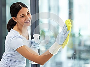 Happy woman, housekeeper and cleaning window with detergent, cloth and gloves for clean hygiene at home. Female person