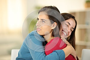 Happy woman hugging a false friend at home