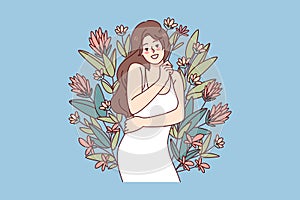 Happy woman hugging herself feeling confident