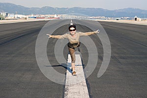 Happy woman imitating airplane photo