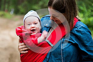 Happy woman with infant baby in forest having fun