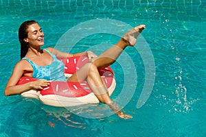 Happy woman and inflatable swim ring in shape of donut