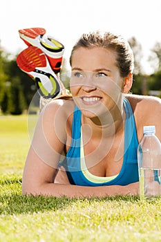 Happy woman jogger training in the park