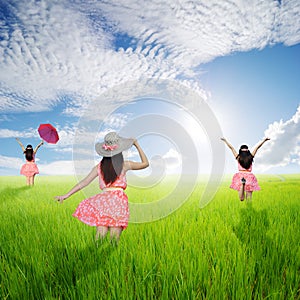 Happy woman jump in green rice fields and blue sky