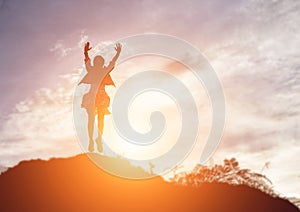 Happy woman jumping against beautiful sunset. Freedom, enjoyment concept