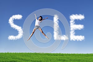 Happy woman jumping on field