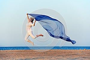 Happy woman jumping on sea beach