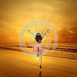 Happy Woman Jumping in Sea sunset