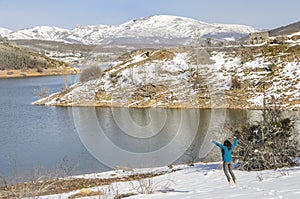 Happy woman jumping in winter mountains in MontaÃÂ±a Palentina