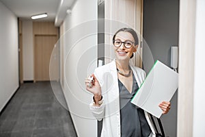 Happy woman with keys of the new apartment