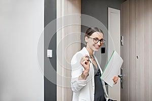 Happy woman with keys of the new apartment