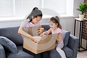 Happy Woman And Kid Opening Received Package