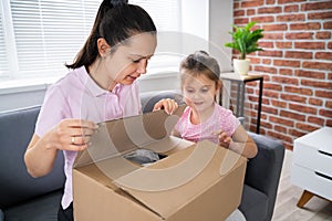 Happy Woman And Kid Opening Received Package