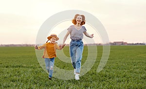 Happy woman with kid running in field