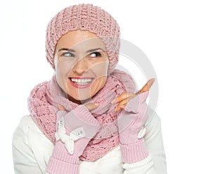Happy woman in knit scarf, hat and mittens