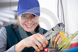 happy woman laborer cutting pipes