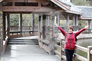 Happy woman by lake of jiuxianshan mountain, adobe rgb