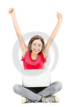 Happy woman with a laptop cheering