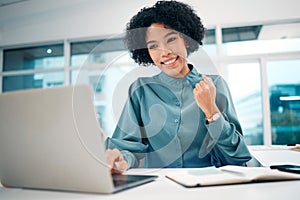 Happy woman, laptop and fist pump in winning, success or promotion for bonus or good news on office desk. Female person