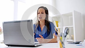 Happy woman with laptop having video conference