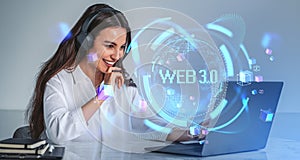 Happy woman with laptop and headphones in office and web 3.0 hologram