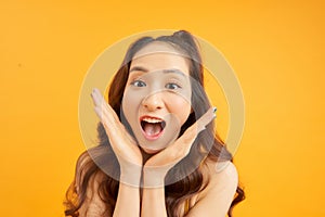 Happy woman Laughing. Cute girl in summertime isolated over orange background