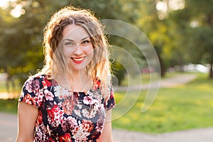 Happy woman laughing hotly on a city street. Close-up attractive caucasian woman with curly hair.