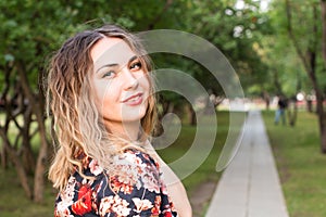 Happy woman laughing hotly on a city street. Close-up attractive caucasian woman with curly hair.