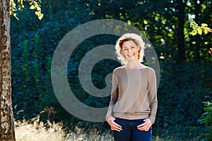 Happy woman laughing outside in nature