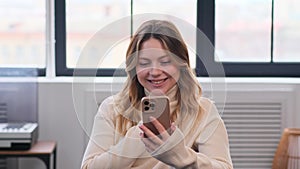 Happy Woman Laughing While Relaxation With Phone On Couch At Home