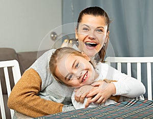 Happy woman laughing and tickle her daughter