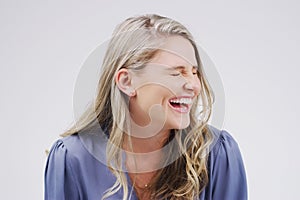 Happy, woman and laughter in studio for funny or comedy for emotions on white background. Smile, female person and