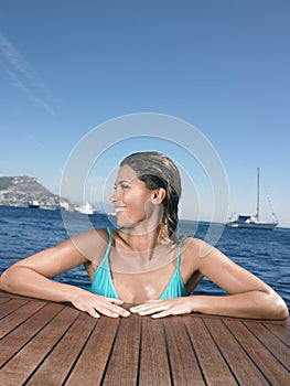 Happy Woman Leaning On Yacht's Floorboard In Sea