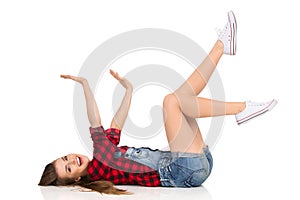 Happy Woman Lies On Her Back With Arms Outstretched