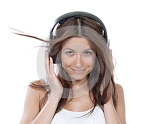 Happy woman listening music in big headphones earphones