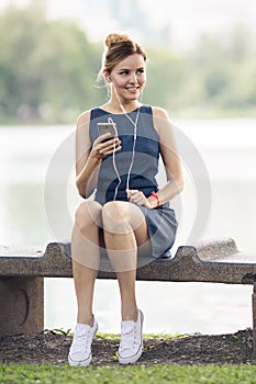 Happy woman listening music on line with headphones