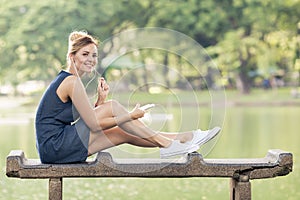 Happy woman listening music on line with headphones