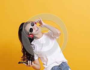 Happy woman listening to music and dancing with headphone