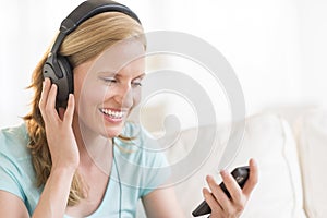 Happy Woman Listening To Music Through Headphones